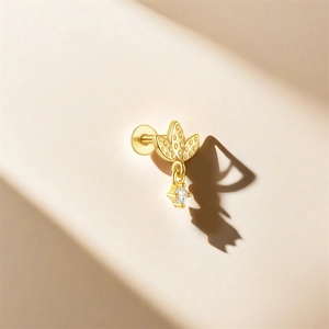 Macro shot of gold S925 leaf earrings with hanging round cubic zirconia stone