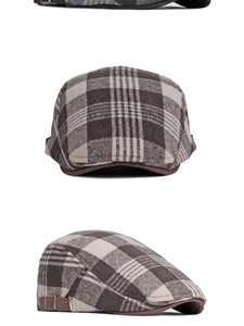 Detail view of the vintage plaid flat cap fabric texture and adjustable metal buckle
