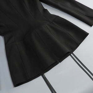 Detail of black structured blazer dress with high-density twill fabric and waist ties