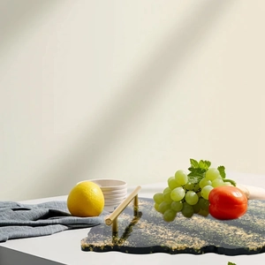 Close-up of irregular resin fruit tray with gold foil flakes and metal handles