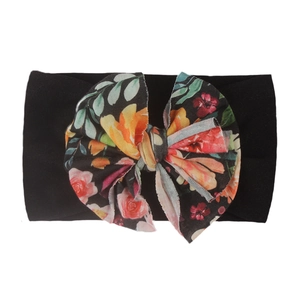 Detail of black nylon baby headband featuring a large colorful floral pattern bow knot