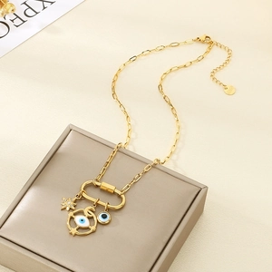 Detailed view of gold stainless steel necklace with evil eye star and moon charms