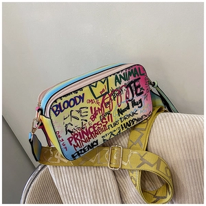 Detail of colorful graffiti crossbody bag with vibrant pastel gradient and thick strap