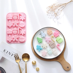Pink silicone Christmas mold with snowman and gingerbread man shapes for festive baking