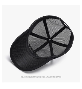 Top view detail of the internal mesh structure of a breathable black trucker cap