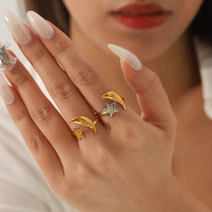 Detail of star and moon open ring showing the two-tone 18K gold and silver plating finish