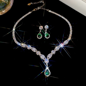 Elegant bridal jewelry set featuring silver necklace and green teardrop gemstone earrings
