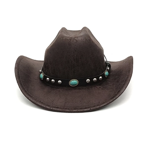 Detail of vintage brown cowboy hat featuring turquoise stones and silver stud trim