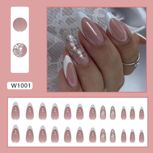 Detail of pink French press-on nails with white tips and silver glitter accents