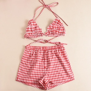 Flat lay of red and white plaid two-piece set featuring halter top and high-waist shorts