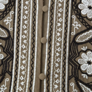 Ethnic style brown linen shirt featuring boho floral embroidery and fabric-covered buttons