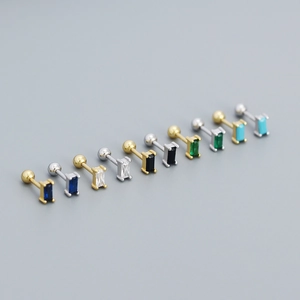 Macro shot of rectangular zircon stud earrings in various colors with gold and silver bases
