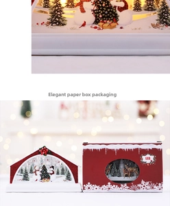 Close-up of LED Christmas light box featuring a snowy scene with a gift packaging box