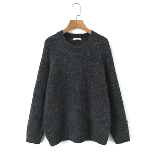 Close-up of dark grey mohair sweater showing fluffy knitted texture and crew neck detail