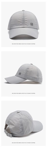 Detail view of light grey quick-dry baseball cap with laser-cut vents and metal buckle
