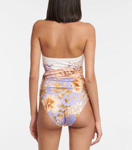 Detail of floral backless swimsuit showing orange flower print and waist tie straps