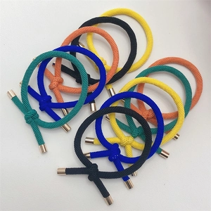 Detail of multi-colored braided elastic hair ties with elegant golden metal cylinders