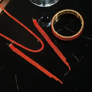 Macro detail of luxury gold-plated jewelry set with sparkling red rhinestone pavé finish