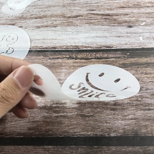 Flexible 20-piece Christmas coffee stencil set with Smile face pattern on wood table