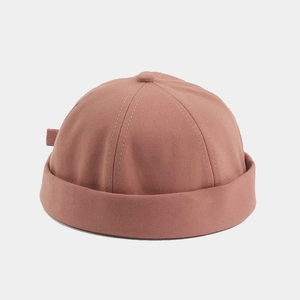 Detail of dusty pink cotton docker hat showing the high-density twill texture and rolled edge