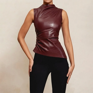 Detail of burgundy faux leather top with side ruching and asymmetrical waist design
