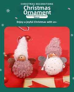 Detail of plush angel Christmas ornaments with glitter wings on festive red background