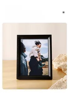 Detail of minimalist black wooden picture frame with visible grain on a desk