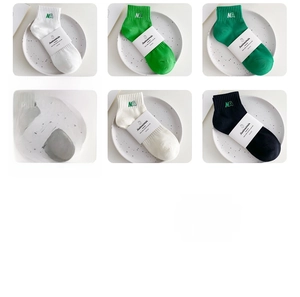 Close-up of six colorful cotton socks with NA embroidery in a neat 3x2 matrix display