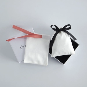 Detailed set of premium white jewelry gift box and soft velvet drawstring pouches with ribbons