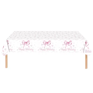 White disposable tablecloth with pink bows and Happy Birthday lettering for parties