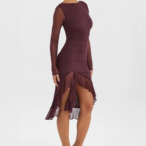Detail of burgundy mesh dress featuring ruched fabric and asymmetric ruffled hemline