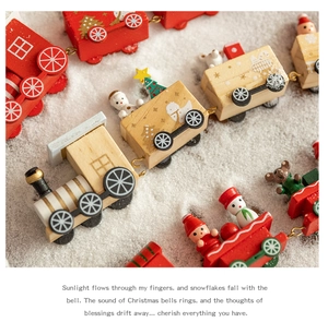 Detail view of a red wooden Christmas train with snowman and tree on artificial snow