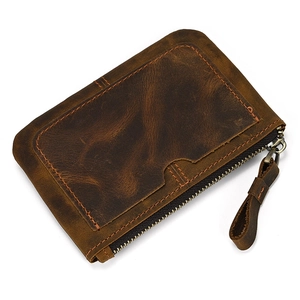 Detailed macro view of vintage crazy horse leather wallet with stitching and zipper