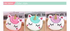Detailed view of plush unicorn coin purses in pink, cyan, and purple with sequined horns