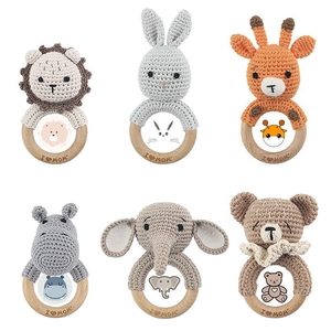 Detail view of 6 handmade crochet animal rattles with I Love Mom engraved on wooden rings
