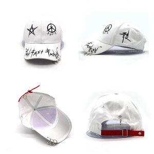 Detail of hip hop graffiti baseball cap featuring metal rings and red adjustable strap
