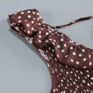 Detailed view of ruffle straps and smocked bodice on brown floral polka dot dress
