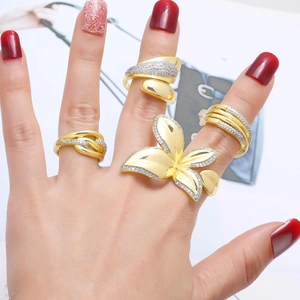 Four-piece gold plated ring set featuring floral design and zircon accents on hand