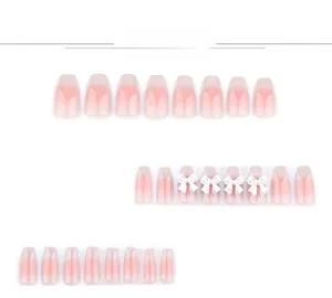 Detail of pink gradient press-on nails featuring 3D white bows and crystal accents