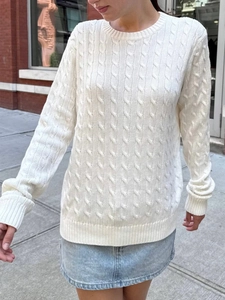 White cable-knit long-sleeve sweater for women featuring a classic crew neck design