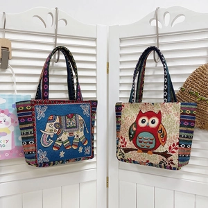 Detail of bohemian tote bags with colorful ethnic embroidery and woven texture