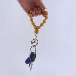 Yellow silicone beaded keychain wristlet with rainbow pendant and glitter accents