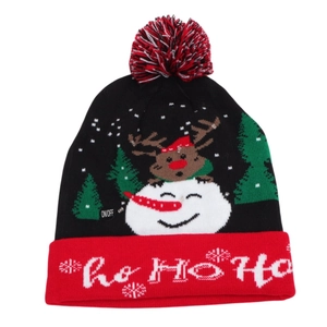 Detail of LED light switch on festive Christmas knitted hat with reindeer patterns