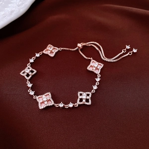 Close-up of rose gold hollow flower bracelet with pink enamel and zircon on silk