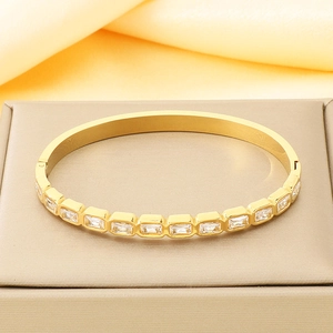 Detailed macro view of 18K gold plated bangle with sparkling rectangular zircon inlay