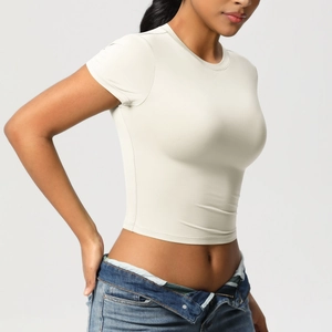 Detail of slim fit beige yoga crop top with high elasticity and fine texture fabric