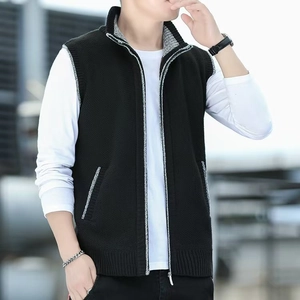 Close-up of men's knitted stand collar vest in black with grey contrast zipper detail
