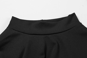 Detail of high-waisted black knitted dress showing fabric texture and wide waistband
