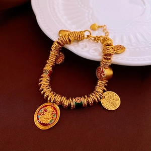 Detail of gold-plated bracelet with enamel beads and Good Fortune Chinese pendants