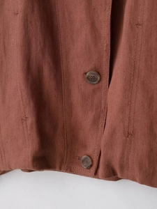 Detailed macro view of retro brown faux suede fabric with vintage brown buttons and stitching